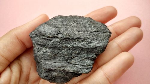 Close-up of hand holding rock