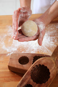 Close-up of person preparing food on cutting board