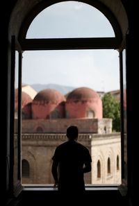 Rear view of man looking at archway