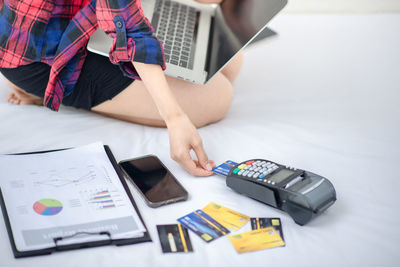 Low angle view of person using laptop on table