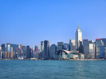 View of buildings in city against blue sky