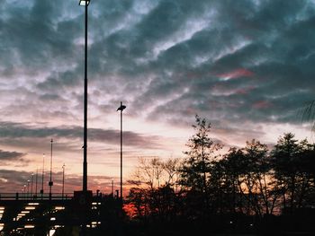 Low angle view of silhouette trees against sky at sunset