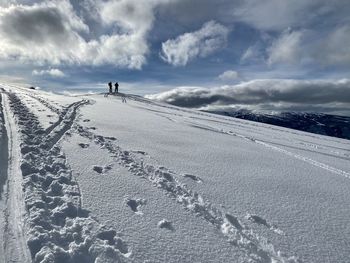 Scenic view of snow covered land against sky