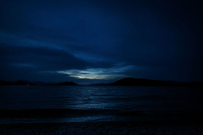 Scenic view of lake against sky at dusk