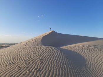 Standing in the top of sand dunes