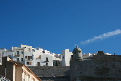 Low angle view of buildings against clear blue sky