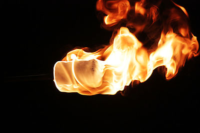 Close-up of fire in dark room