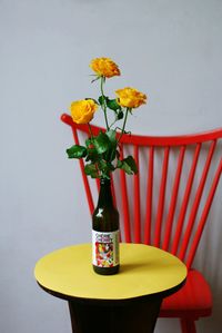 Close-up of yellow flowers in vase on table