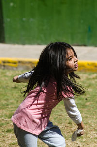 Rear view of girl wearing hat on field