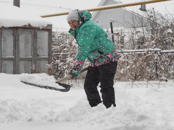 Low section of man skiing on snow