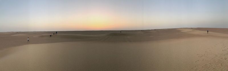 Scenic view of desert against sky during sunset