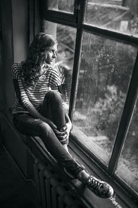 Woman sitting by window