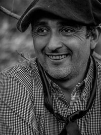 Close-up of thoughtful man smiling outdoors