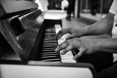 Close-up of hands playing piano