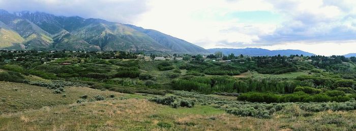 Scenic view of mountains against cloudy sky