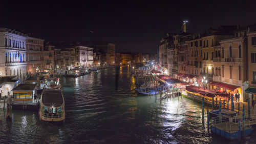 High angle view of boats moored in canal at night