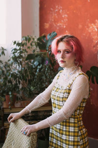 Young fashion stylish woman standing vintage studio, bright make up 