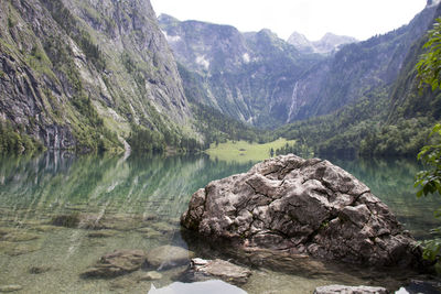 Rocks by lake against mountains