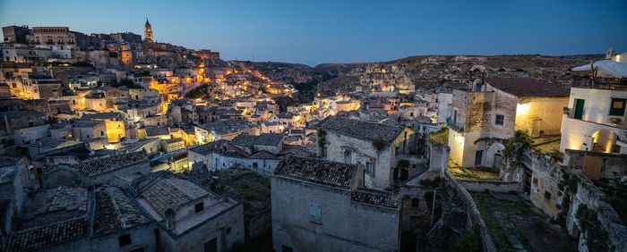 Panoramic view of illuminated cave dwellings at sassi di matera