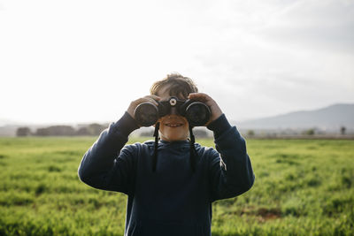 Full length of man standing on field against sky