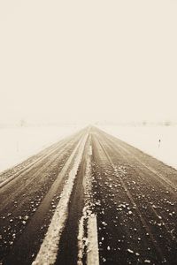 Surface level of road against sky during winter