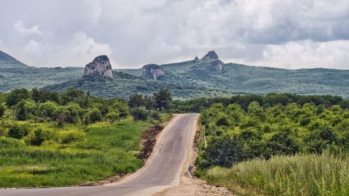 Road amidst landscape against sky