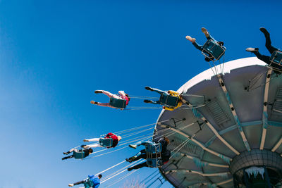 Low angle view of ferris wheel against sky