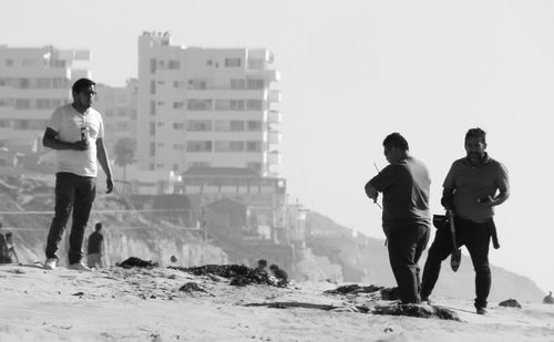 Full length of men standing on land against sky