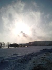 Scenic view of snow covered land against sky