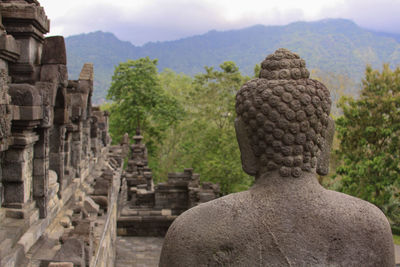 Visitors at borobudur temple. landscape full view from temple base the largest buddhist temple