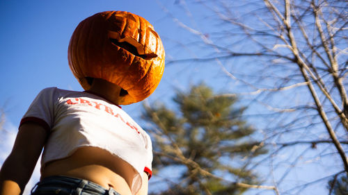 Low angle view of man holding lantern