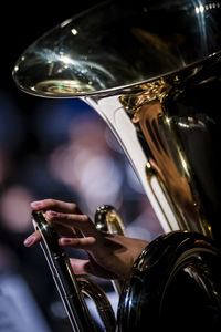 Cropped image of person playing tuba on stage