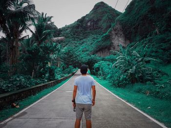 Rear view of man walking on mountain