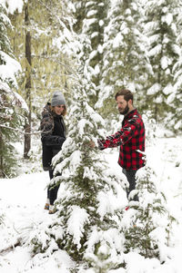 Man and woman picking out christmas tree