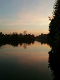 Scenic view of calm lake at sunset