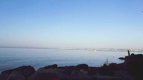 Scenic view of sea against clear blue sky