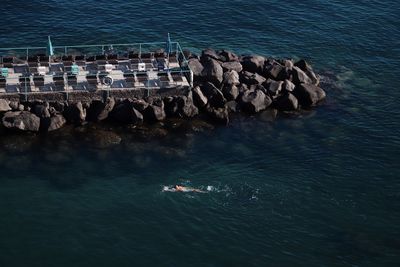 High angle view of rocks in sea