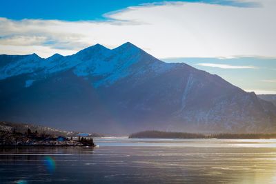 Scenic view of sea and mountains against sky