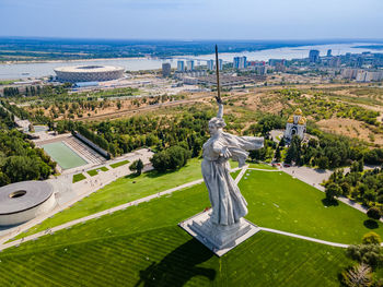 High angle view of city by sea against sky