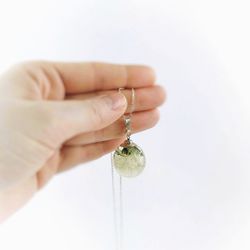 Close-up of hand holding glass over white background