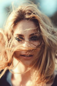 Portrait of young woman with messy hair outdoors