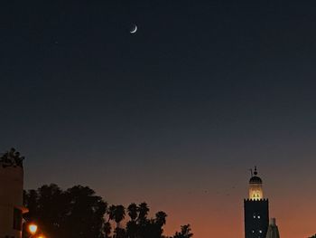 Low angle view of buildings against sky at night