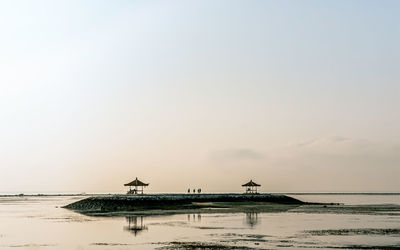 Scenic view of sea against clear sky during sunset