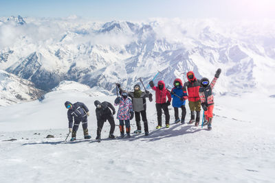 People skiing on snowcapped mountains during winter