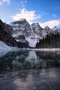 Scenic view of lake and snowcapped mountains against sky