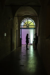 People walking in corridor of building