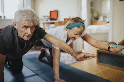 Senior couple doing yoga at home