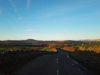 Road amidst landscape against clear sky