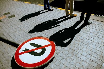 High angle view of road sign fallen on street