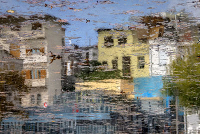 Reflection of buildings in puddle